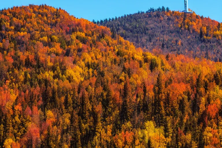 Image similar to a mountain with a radio tower next to a pond, autumn hills in background. telephoto lens photography.