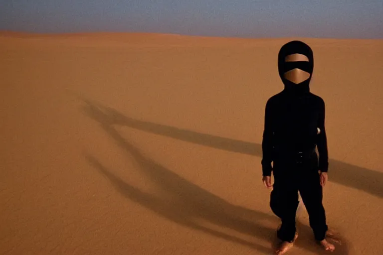 Image similar to a cinematic portrait of a boy wearing a black outfit and a mask connected to water, in a serene vast desert, dune movie, cinematic, movie still, dramatic lighting, by bill henson, 1 6 : 9 ratio