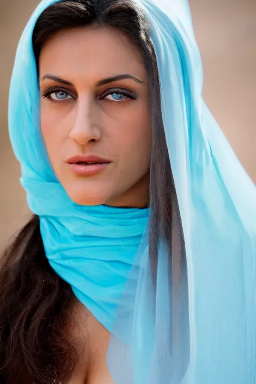 Image similar to young Monica Belluci as an Arab woman, tanned skintone, bright blue eyes, white transparent veil, headscarf, light blue long sleeves dress, closeup portrait, focus face