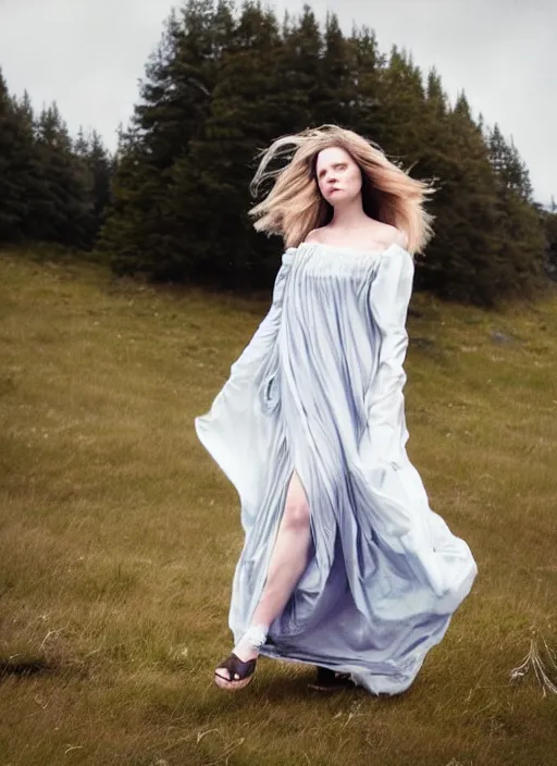 Image similar to cinestill 5 0 d portrait photo of a beautiful woman, nordic type, delicate, subsurface scattering, long hair floating in air in style of annie liebovitz, 1 5 0 mm, windy mood, dress in voile, mute dramatic colours, soft blur outdoor stormy background, volumetric lighting, hyper detailed, hyper realistic