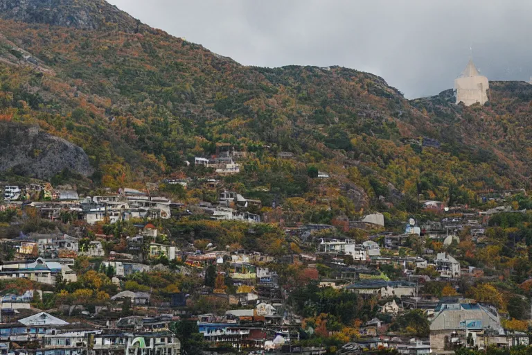 Image similar to warehouses lining a street, with an autumn mountain directly behind, radio tower on mountain, lens compressed, photography