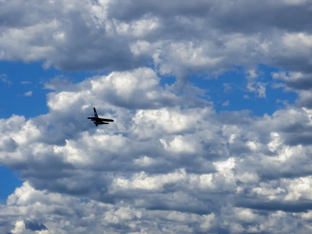 Prompt: clouds, horizontal skyscraper flying towards planes in the sky