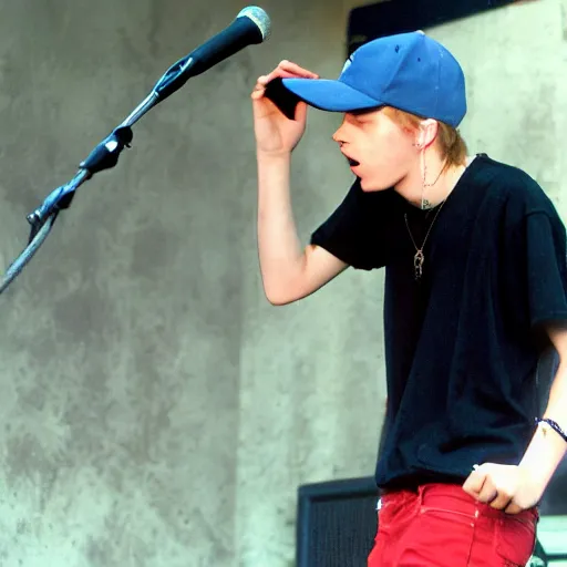 Image similar to 19-year-old white boy wearing backwards baseball cap, baggy jeans, rapping into microphone, nü metal concert, rap metal, alternative metal, 1999 photograph