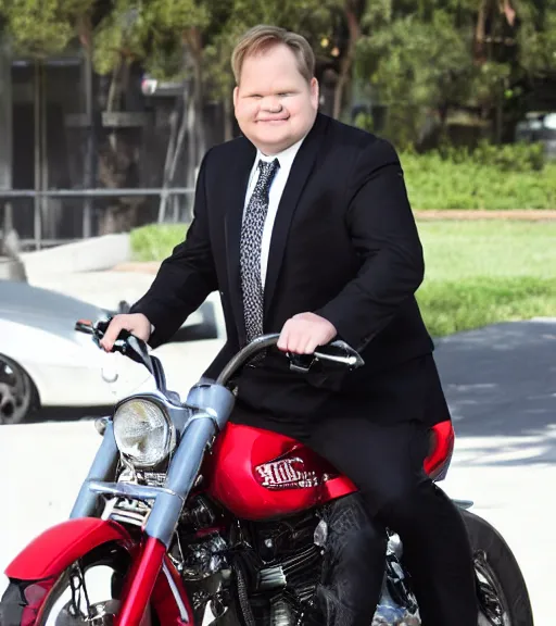 Image similar to Andy Richter is dressed in a black suit and a red necktie and riding a motorcycle into a television studio lot. There are Soundstages and movie caravans on the studio lot. It is a bright afternoon and overcast.