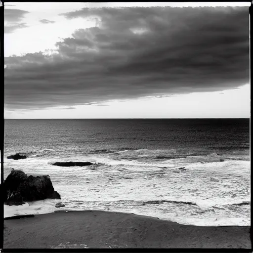 Prompt: california beach sunset on film, shot with an analog camera, black and white, looking out at the ocean, photography, noisy