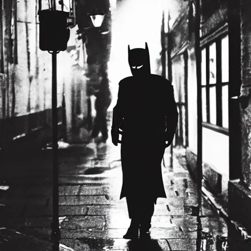 Image similar to 1900's photo of batman with frowning in deep alley street holding his emotion while walking slowly towards a street lamp, rain and smokes while the moon shines on his back, blurry, candid