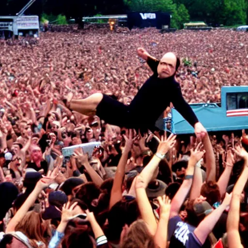 Image similar to george costanza at the vans warped tour on stage, crowd surfing
