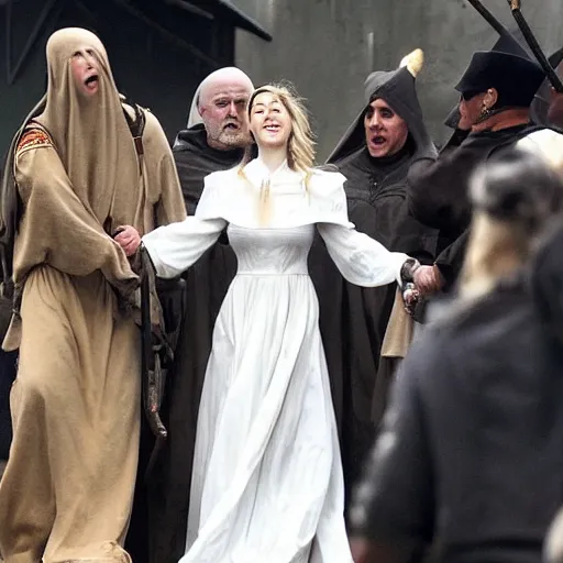 Image similar to Amber Heard as Joan of Arc being led to the gallows, she is wearing prison rags, she is laughing, the crowd is cheering