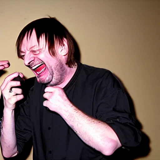 Image similar to Mark E Smith laughing at Fred Durst who is crying and screaming