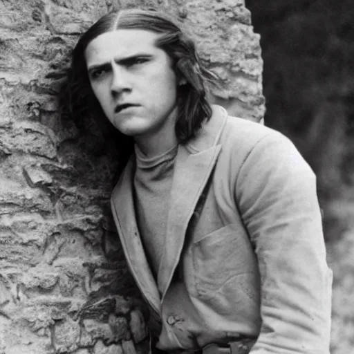 Prompt: Still of a color movie set in the 1930s where a young man with long hair is backed against a stone wall looking utterly panicked and distressed