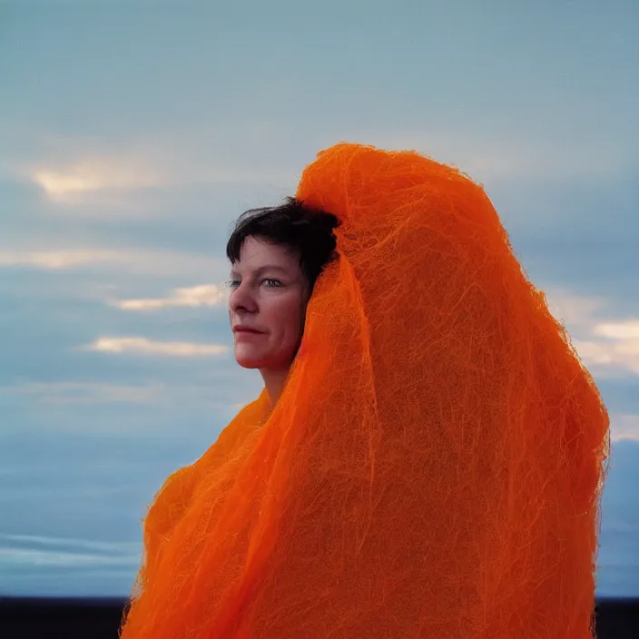 Prompt: closeup portrait of a woman wrapped in orange fiber, standing in alaska, aurora i in background, color photograph, by vincent desiderio, canon eos c 3 0 0, ƒ 1. 8, 3 5 mm, 8 k, medium - format print