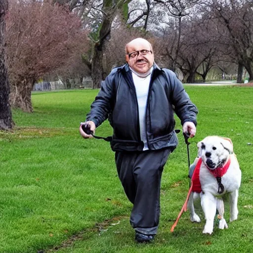 Image similar to a dog that looks like danny devito going for a walk in the park with its owner