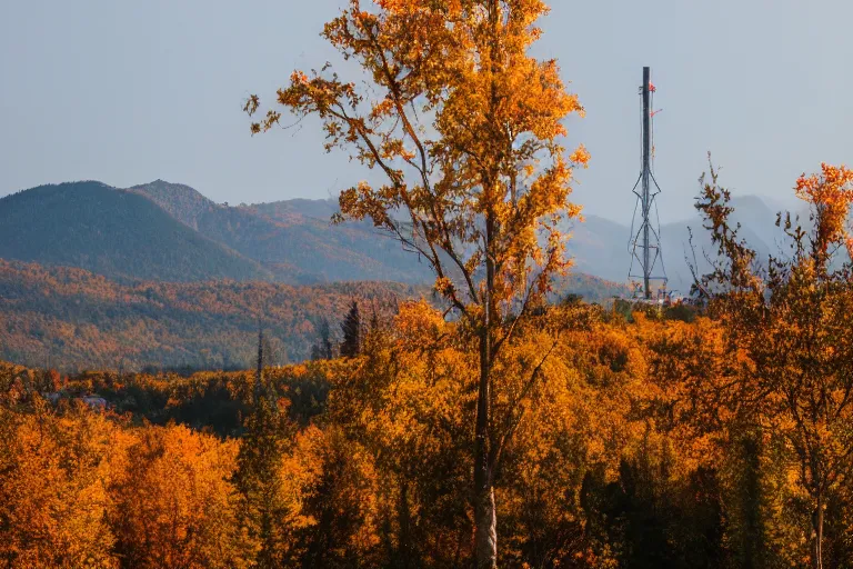 Image similar to a mountain with a radio tower next to a pond, autumn hills in background. telephoto lens photography.