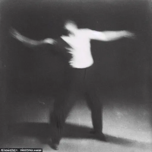 Image similar to a smudged, grainy and blurry photograph showing the whole body of a man dynamically and frenetically dancing in a dark room, edwardian photograph, taken with soviet flash camera at slow shutter speed