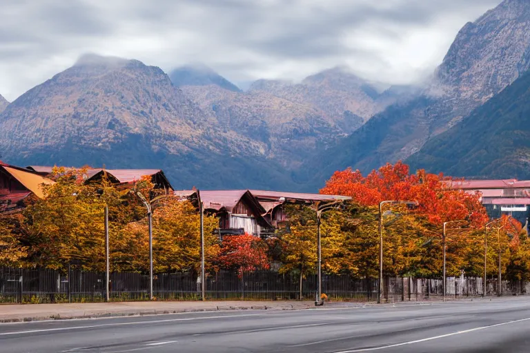 Image similar to warehouses lining a street, with an autumn mountain directly behind, lens compressed, photography