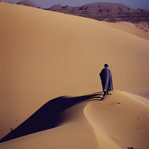 Prompt: medium format photograph of bedouin man on steep dune, ektachrome, hasselblad film shallow focus portrait, soft light photographed on expired color film,