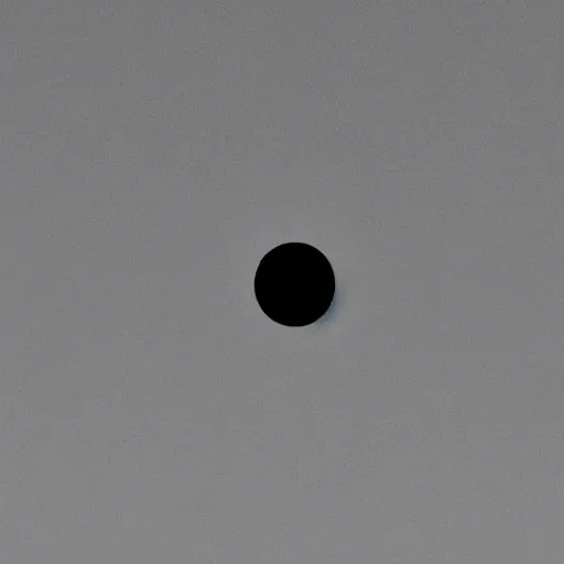 Image similar to a black dot in the sky, unsettling, liminal space