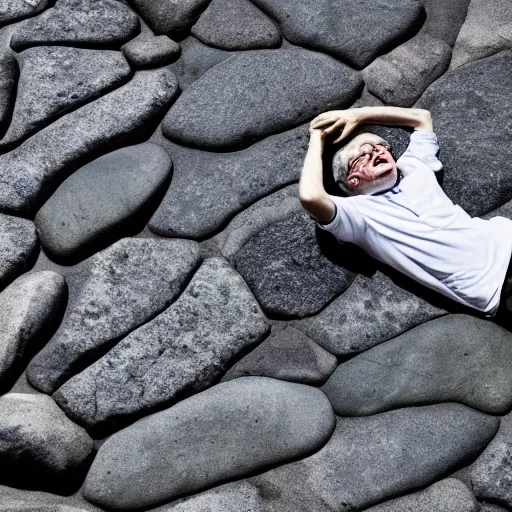 Image similar to stephen hawking laying on rocks, photography, 8 k,