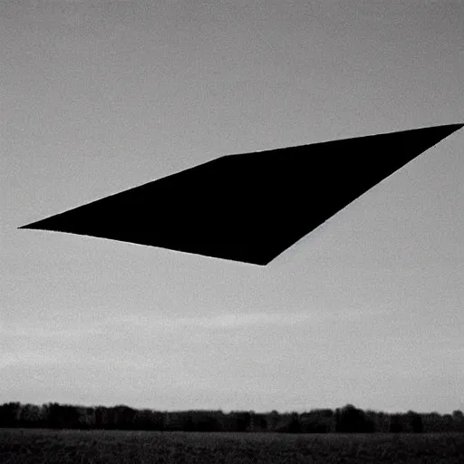 Image similar to a 1 9 9 0 photograph of a diamond shaped ufo over a field, grainy, photo realistic