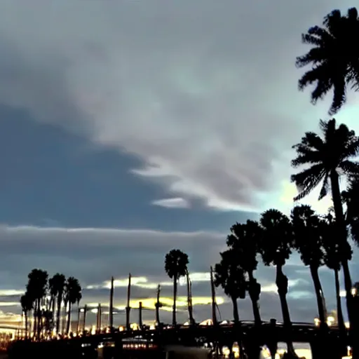 Prompt: blue hour, mostly cloudy sky, palm trees, bridge, curved bridge, dusk, 2 4 0 p footage, 2 0 0 6 youtube video, 2 0 0 6 photograph, low quality photo, home video