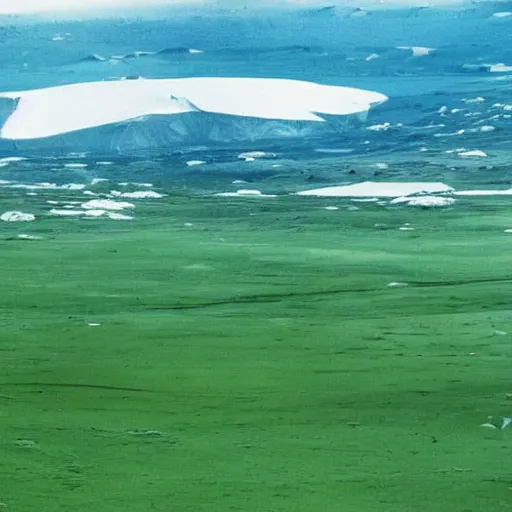 Prompt: strange part of antartica, green valley below, lush and green, green pastures stretch for miles, secret photograph of declassified ufo base in antarctica, operation highjump, recolored, 4 k