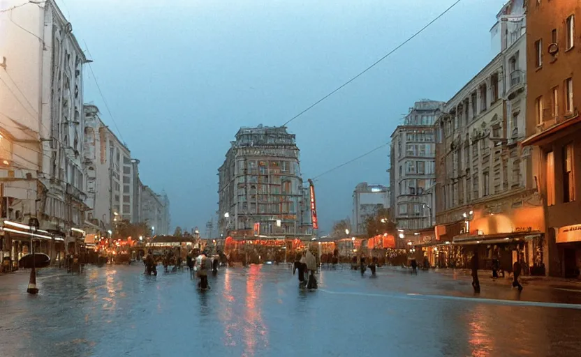 Prompt: 1990s movie still of a yougoslavian street with many pedestrians with stalinist style highrise, Cinestill 800t 18mm, heavy grainy picture, very detailed, high quality, 4k panoramic, HD criterion, dramatic lightning, streetlight at night, rain, mud, foggy, many CCCP flags