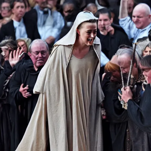 Image similar to Amber Heard as Joan of Arc being led to the gallows, she is wearing prison rags, she is laughing, the crowd is cheering