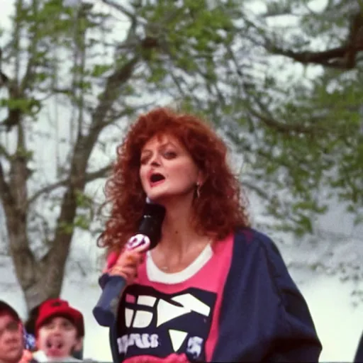 Prompt: 1 9 9 0 s video still of susan sarandon, wearing a hip hop hoodie, rapping on stage at a small outdoor concert, vhs artifacts