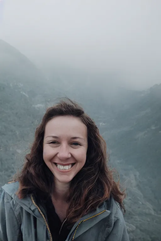 Prompt: film still, extreme close-up, woman smile, fog, mountains in distance, 35mm