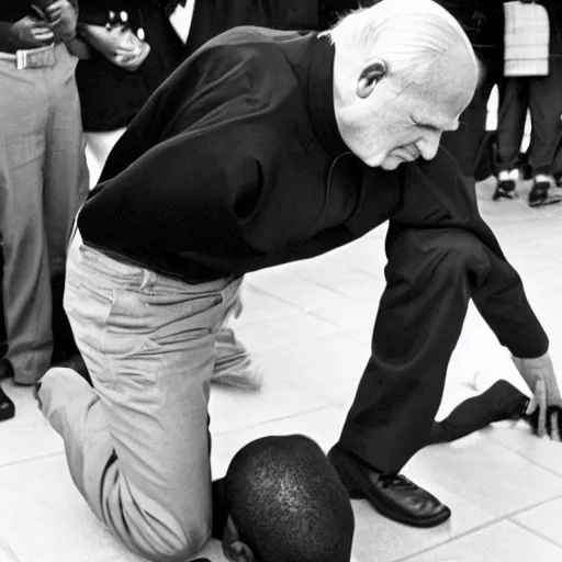 Image similar to John Paul II kneeling on a black person's neck