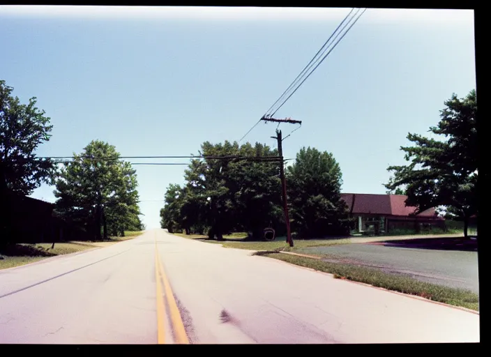 Image similar to A disposable camera picture of an empty street in a small rural American suburb, Kodak Fling 200, 1983