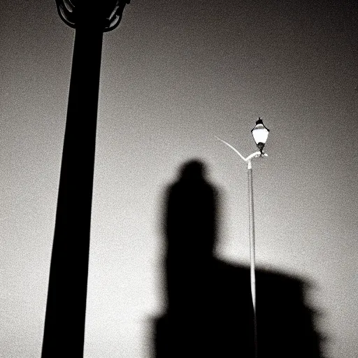 Image similar to tall man shadow on street lamp at night, 8 mm, found footage