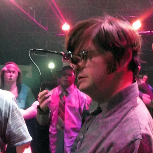 Prompt: Dwight schrute on stage at a hip hop concert throwing beets at the crowd