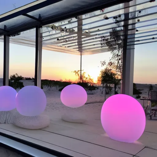 Image similar to An ultra high definition, professional photograph of an outdoor partial IKEA showroom inspired sculpture with a white outdoor dot matrix light sign displaying an emoji, located on a pastel pink beach ((with pastel pink, dimpled sand where every item is pastel pink. )) The sun can be seen rising through a window in the showroom. The showroom unit is outdoors and the floor is made of dimpled sand. The showroom unit takes up 20% of the frame and is surrounded by barren beach environment. A square dot matrix sign displays an emoji somewhere in the scene. Morning time indirect lighting with on location production lighting on the showroom. In the style of wallpaper magazine, Wes Anderson.