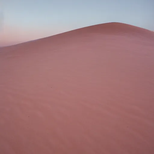 Image similar to two transparent speakers in a pale pink sand dune at dawn