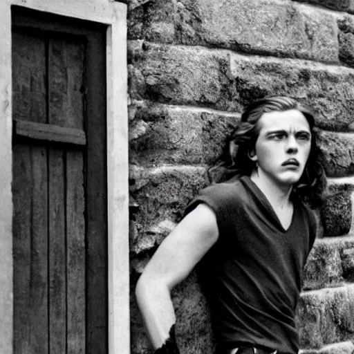 Image similar to Still of a modern movie set in the 1930s where a young man with long hair is backed against a stone wall looking utterly panicked and helpless