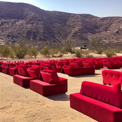 Image similar to pov seen from the stands of an outdoor show in a desert, the seats are in red velvet and comfortable, the stage is surrounded by wooden barriers