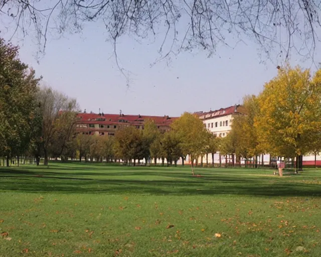 Image similar to a park with trees and buildings in the background, a photo by zlatyu boyadzhiev, deviantart, danube school, panorama, 1 9 9 0 s, creative commons attribution