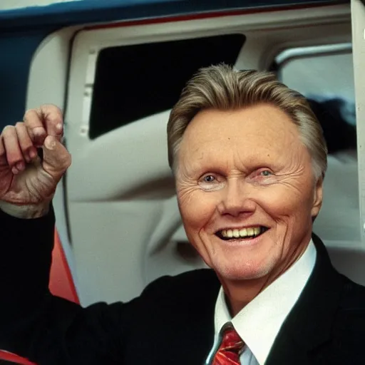 Image similar to john voight is sitting in a van, door open, looking at camera and smiling, he holds up his arms, showing his handcuffs