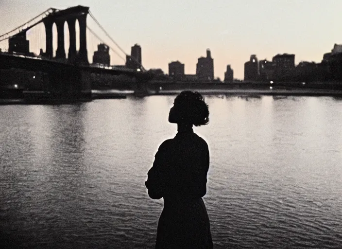 Image similar to a 35mm photograph from the back of a woman standing at the edge of a river in Harlem, New York City in the 1960's at sunset, bokeh, Canon 50mm, cinematic lighting, photography, retro, film, Kodachrome, award-winning, rule of thirds, golden hour