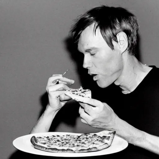 Image similar to a photo of andy warhol eating a delicious slice of pizza