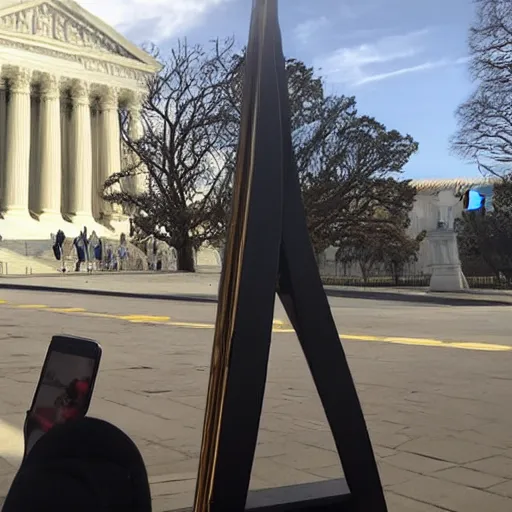 Prompt: Phone camera photo of a guillotine outside the supreme court