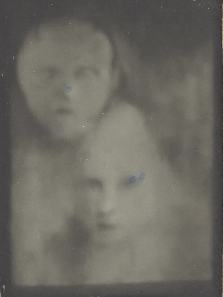 Image similar to found tintype photograph. a ghost's face in a tudor house window