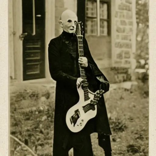 Prompt: vintage photograph of count orlok crouched outside his castle, playing the blues on guitar, 4 k