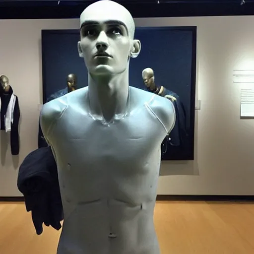 Image similar to “ a realistic detailed photo of a guy who is an attractive humanoid who is half robot and half humanoid, who is a male android, soccer player antoine griezmann, shiny skin, posing like a statue, blank stare, at the museum, on display ”