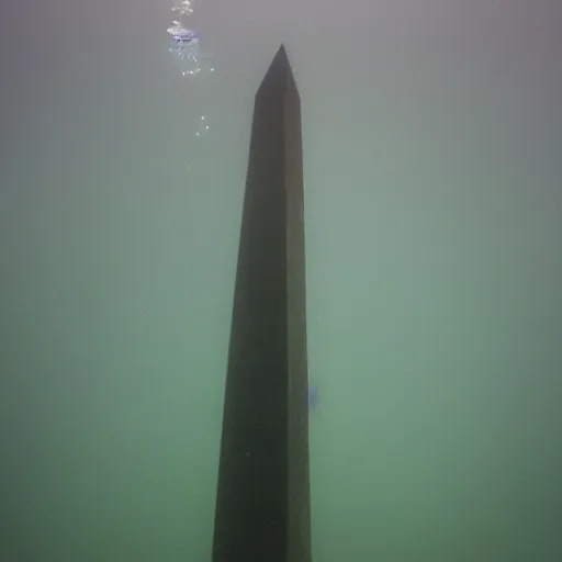 Image similar to a large obelisk floating underwater. grainy.