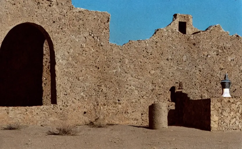 Image similar to movie still: in a desert, a ruined Mexican bell tower. In the foreground lies a bell, half-buried in the ground, by David Bailey, Cinestill 800t 50mm eastmancolor, heavy grainy picture, very detailed, high quality, 4k, HD criterion, precise texture