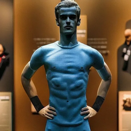 Image similar to “ a realistic detailed photo of a guy who is an attractive humanoid who is half robot and half humanoid, who is a male android, soccer player antoine griezmann, shiny skin, posing like a statue, blank stare, at the museum, on display ”