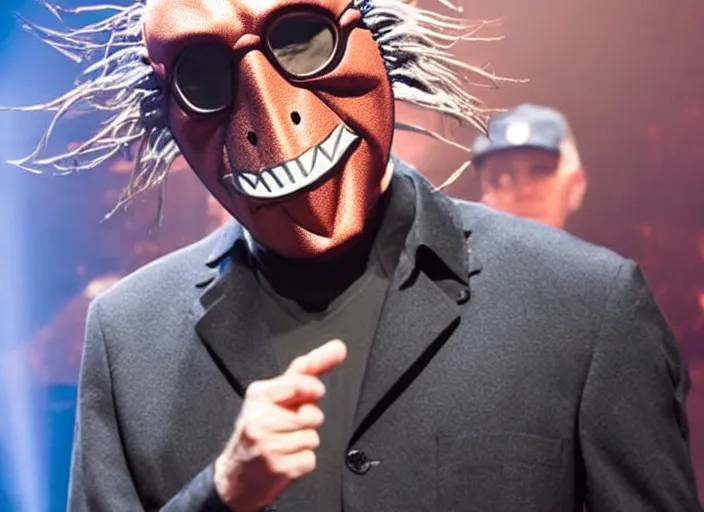 Image similar to publicity photo still of larry david wearing a slipknot mask touring with slipknot live on stage, 8 k, live concert lighting, mid shot