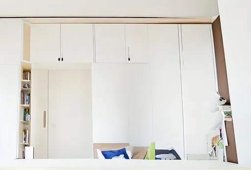 Prompt: An interior of this room which includes a single bed, a spacious wardrobe and a study table